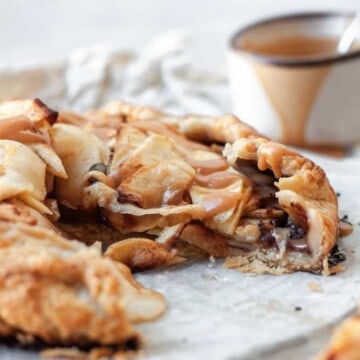 A caramel chocolate apple galette with a piece missing