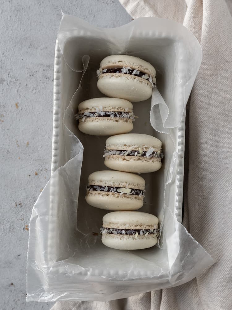 A small dish with five almond joy macarons