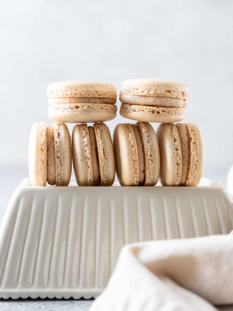 A stack of apple pie macarons on a dish