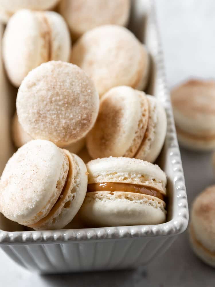  a small dish filled with churro macarons