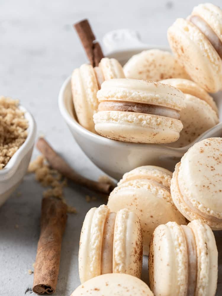 cinnamon roll macarons in a small bowl 