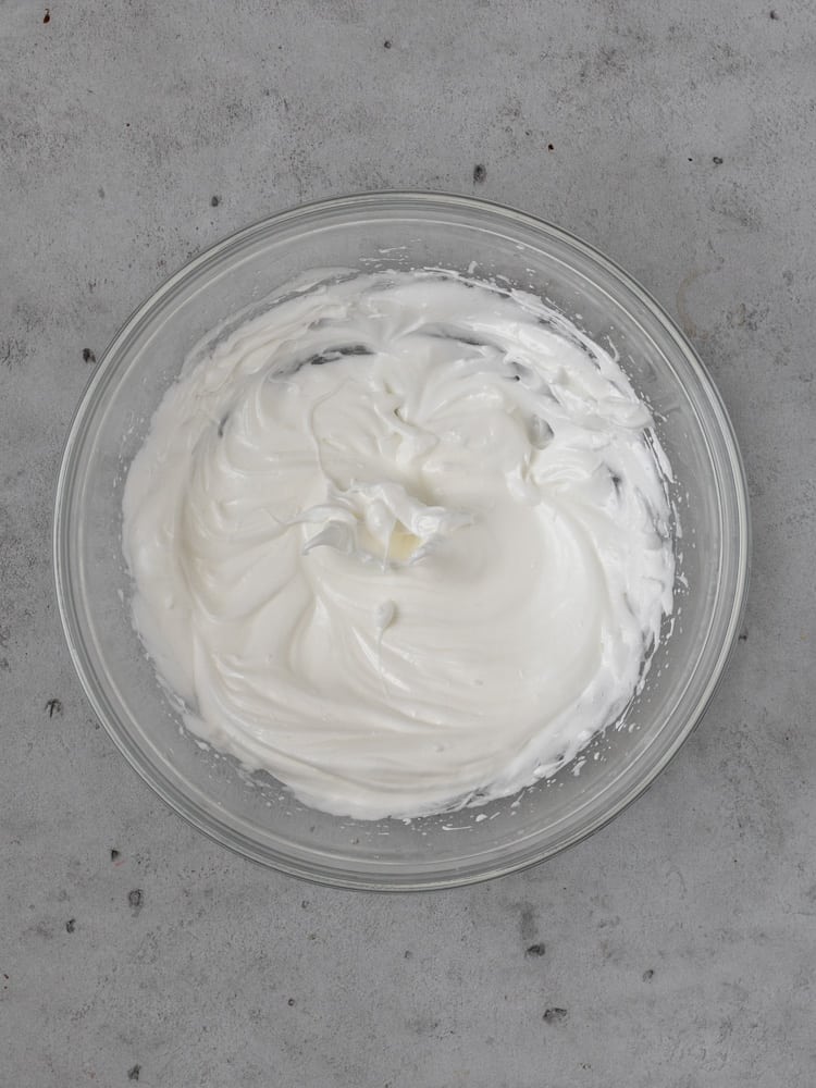 A bowl of french meringue whipped to stiff peaks