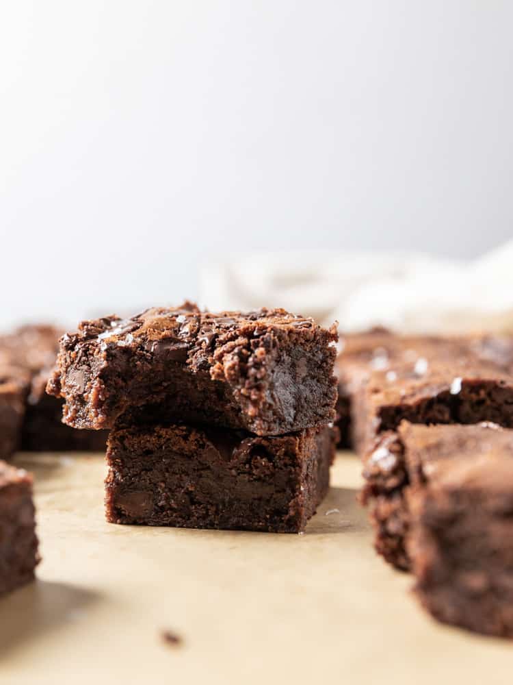 Two brownies stacked, one with a bite out of it