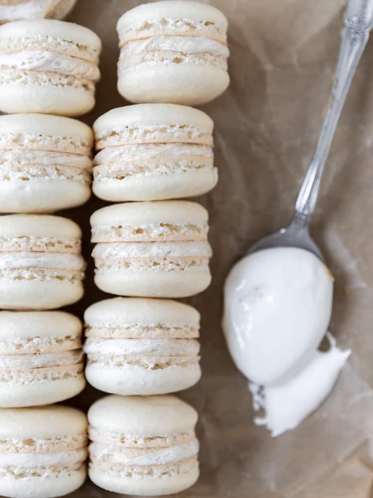 Looking down on a row of macarons and a spoonful of marshmallow fluff