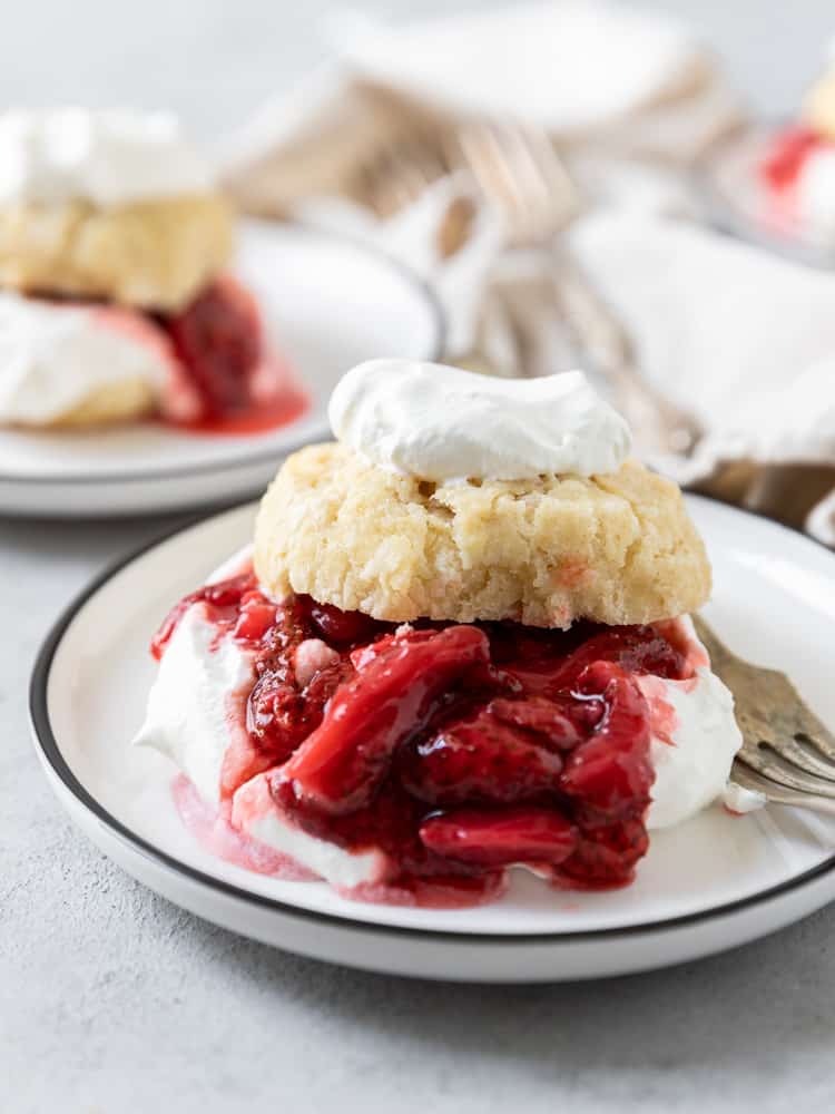 A close up of a roasted strawberry shortcake on a plate