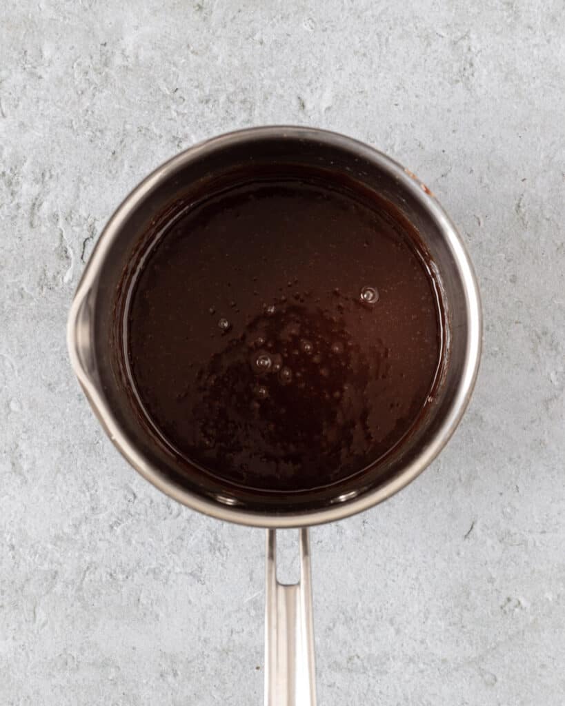 The chocolate glaze in a sauce pan