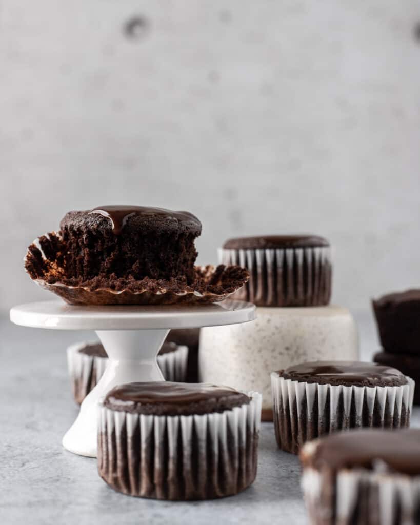 A chocolate cupcake on a small cake stand