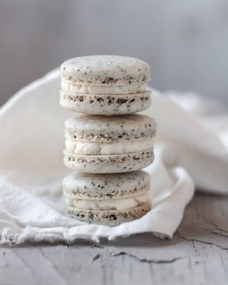 Three earl grey macarons stacked on top of each other