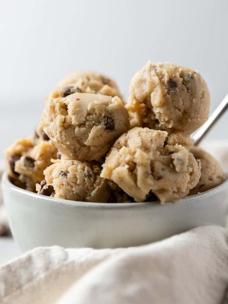 A close up of scoops of cookie dough in a bowl