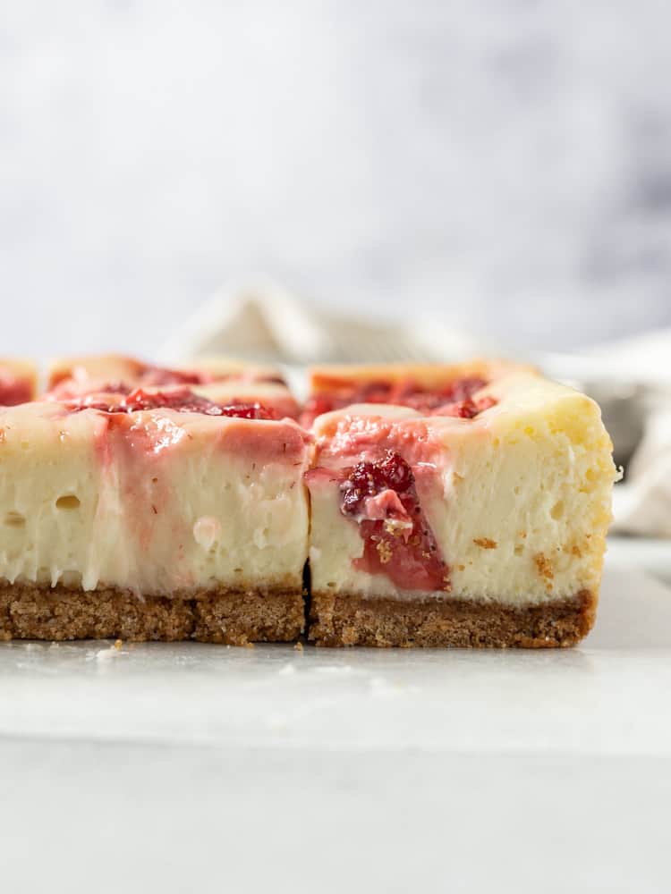 A side view of roasted strawberry cheesecake bars