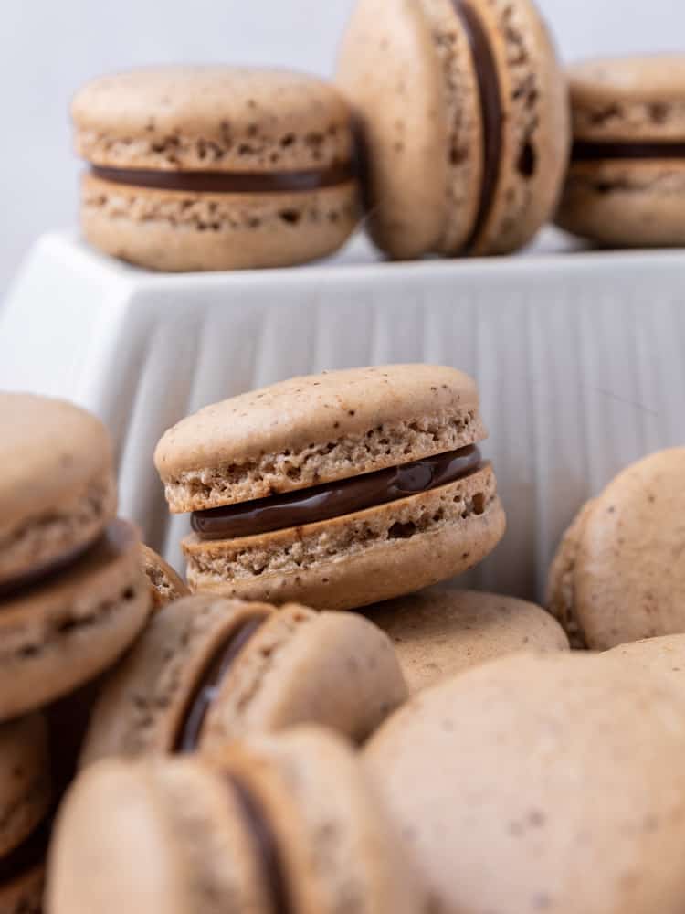 A close up of a coffee nutella macaron
