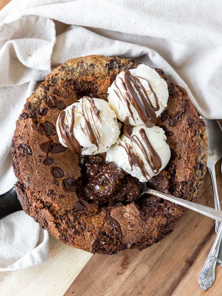 Looking down on a Nutella Skillet Cookie with three scoops of ice cream on top