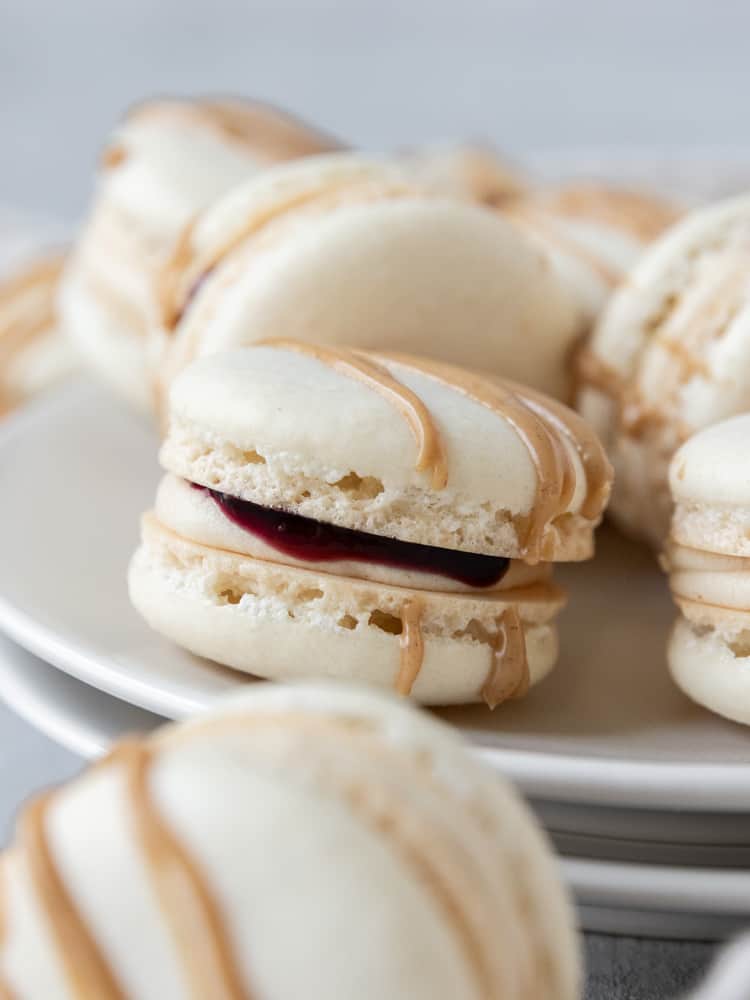A closeup of a peanut butter and jelly macaron on a plate