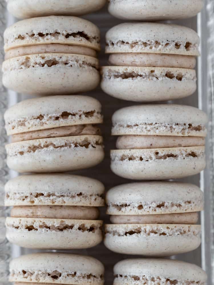 A closeup of two rows of pumpkin spice macarons