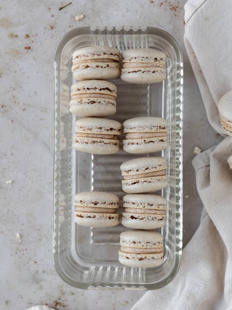 Looking down on a dish with pumpkin spice macarons, some are missing