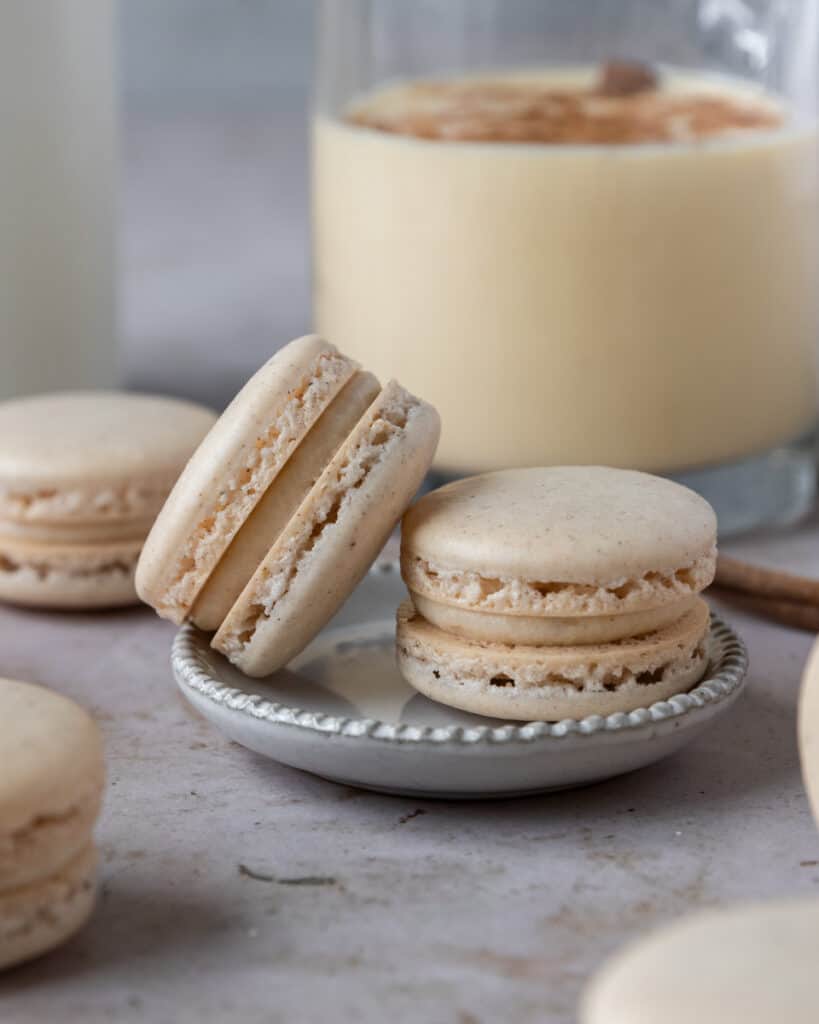 a close up of two french macarons on a small plate
