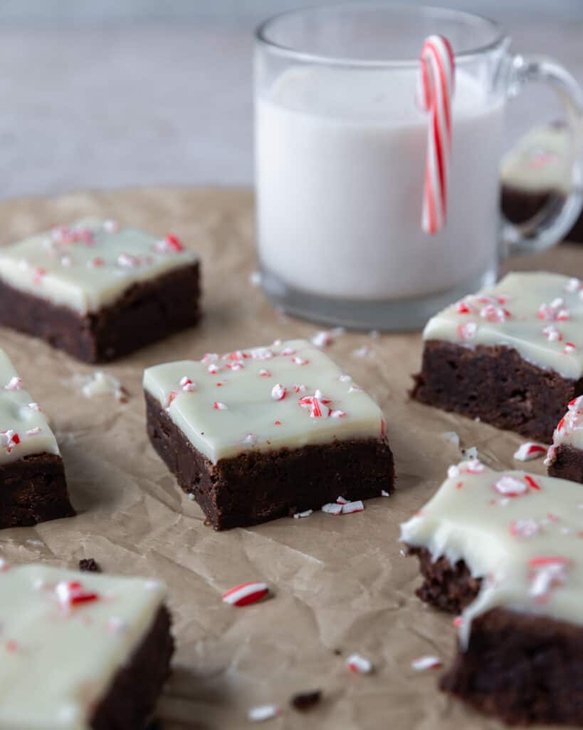 peppermint bark brownies on a board with a cup of peppermint bark liqueur