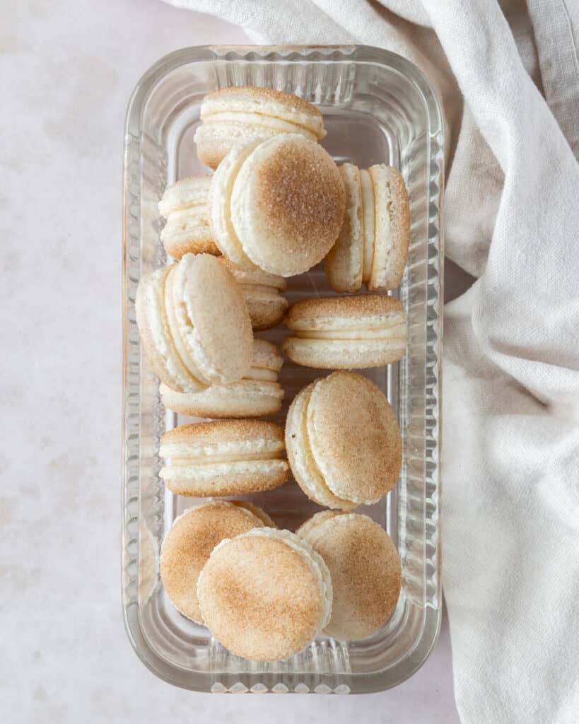 a pile of macarons in a glass dish