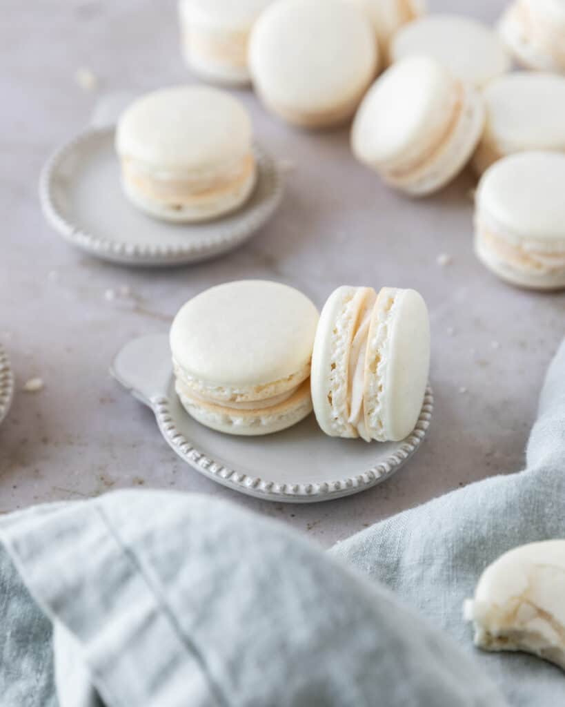 two brown butter macarons on a small plate