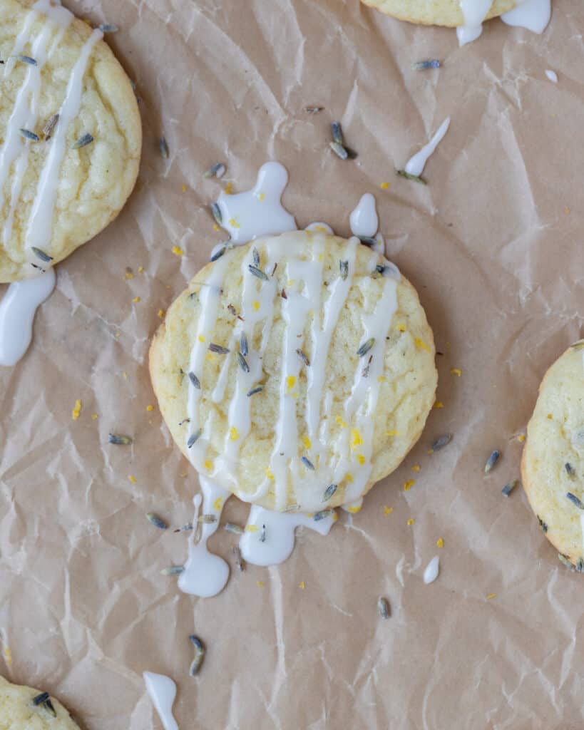 looking down at a lemon lavender cookie drizzled with lemon glaze and sprinkled with dried lavender and lemon zest
