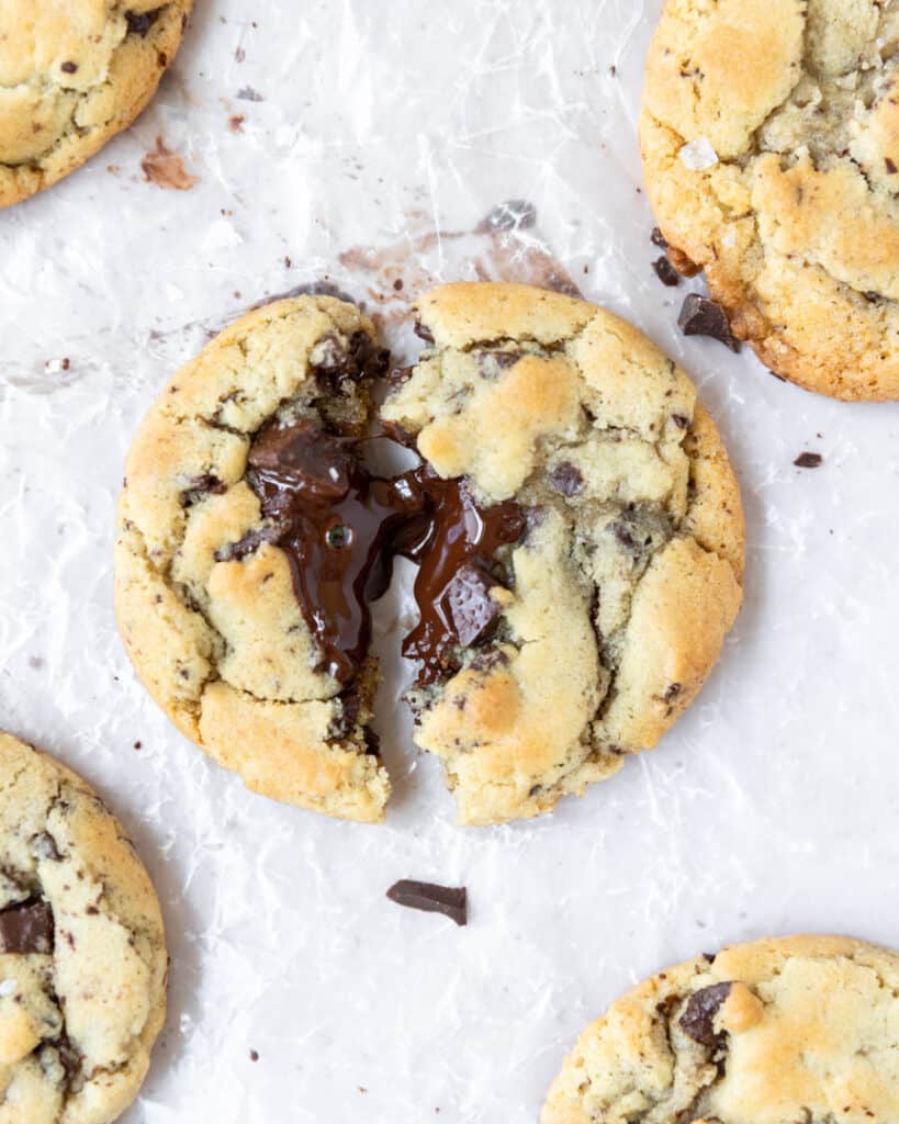 a cookie split in half with chocolate spilling out of the middle