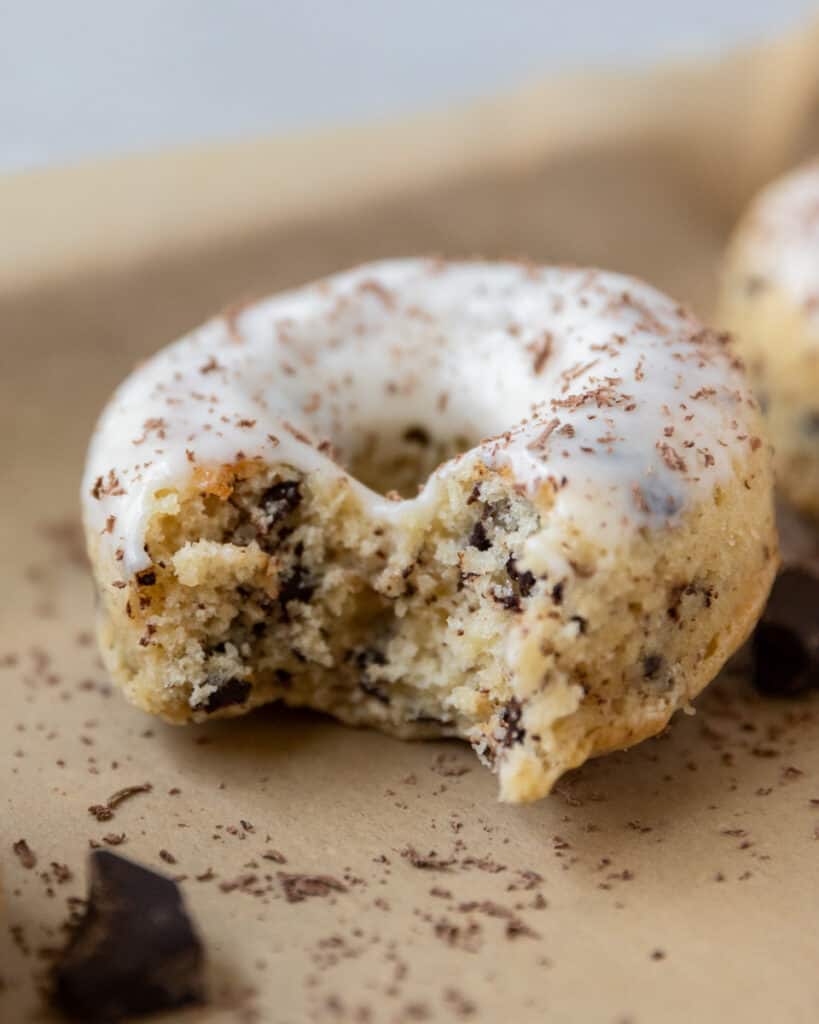 a close up shot of a baked donut with a bite out of it