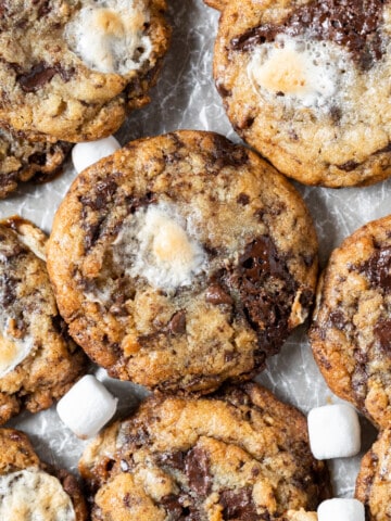 several chocolate chip marshmallow cookies on a white background