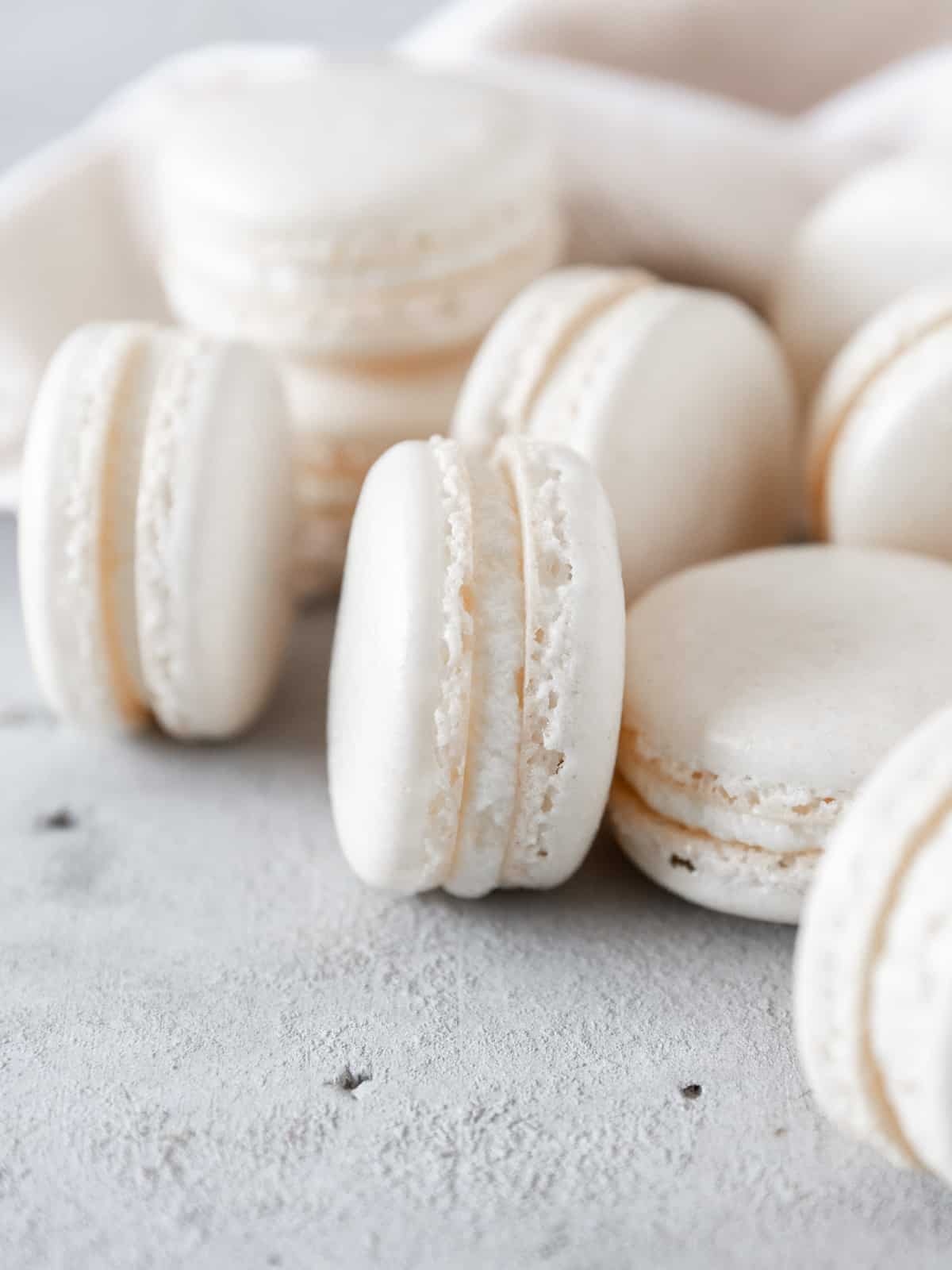 macarons laid out and stacked together on a grey background