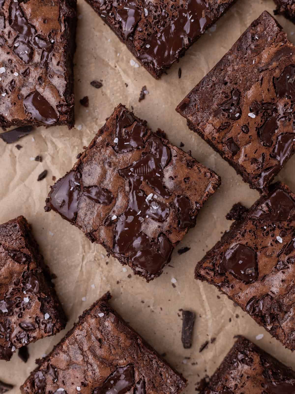 a tray of fudgy brownies with chunks of chocolate on top and sprinkled with salt
