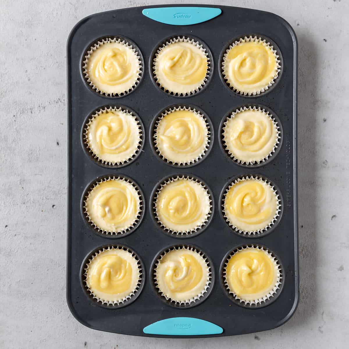 the mini lemon cheesecakes in the muffin tin before being baked