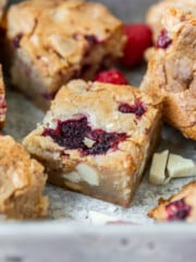 several white chocolate and raspberry blondies in a metal baking dish