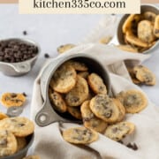 three cups full of mini chocolate chip cookies and one full of mini chocolate chips on a linen napkin. It says mini chocolate chip cookies across the top.