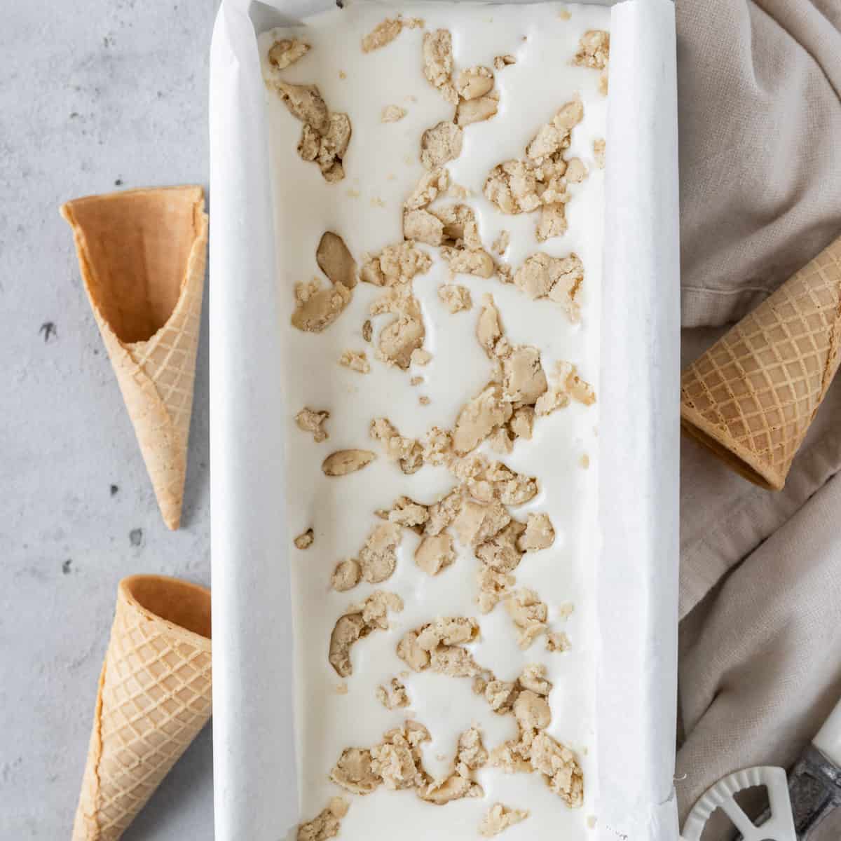 the cookie dough ice cream recipe poured into a metal pan.