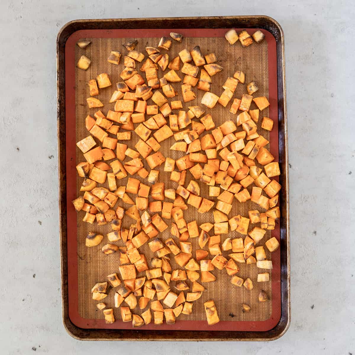 the sweet potatoes on a baking sheet after being baked.