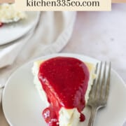 a slice of white chocolate cheesecake topped with raspberry sauce on a white plate with a fork next to it. It says white chocolate cheesecake across the top.