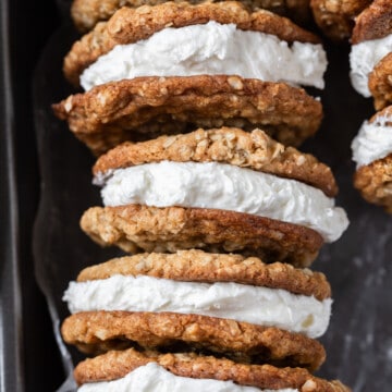 a row of oatmeal cream pies in a metal baking pan.