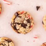 a peppermint cookie surrounded by other cookies, pieces of chocolate, and peppermint.