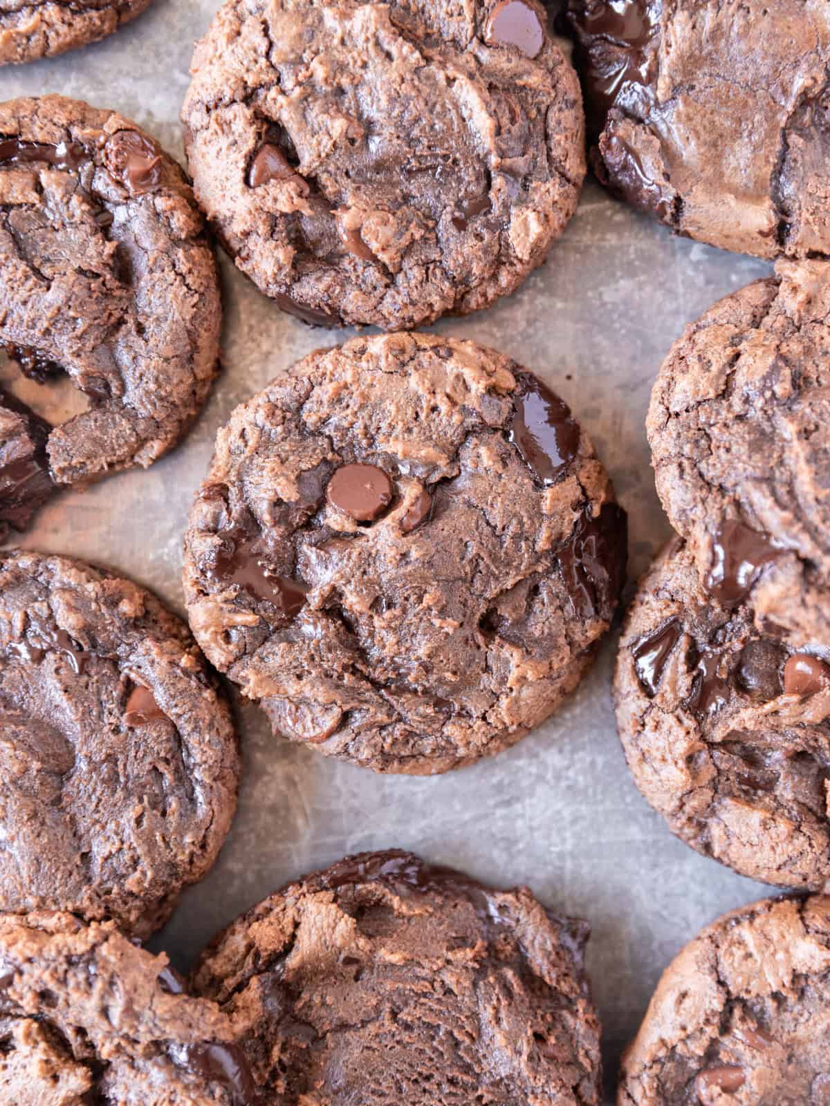 several brownie mix cookies on a metal baking sheet.