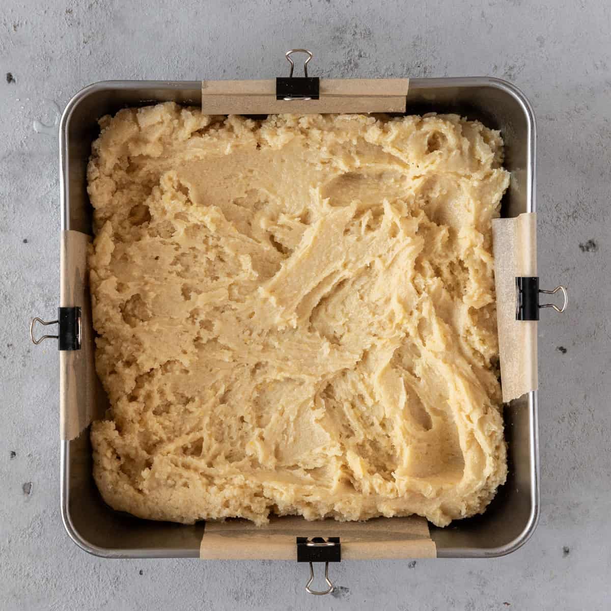 the lemon brownie batter in a metal baking dish before being baked.