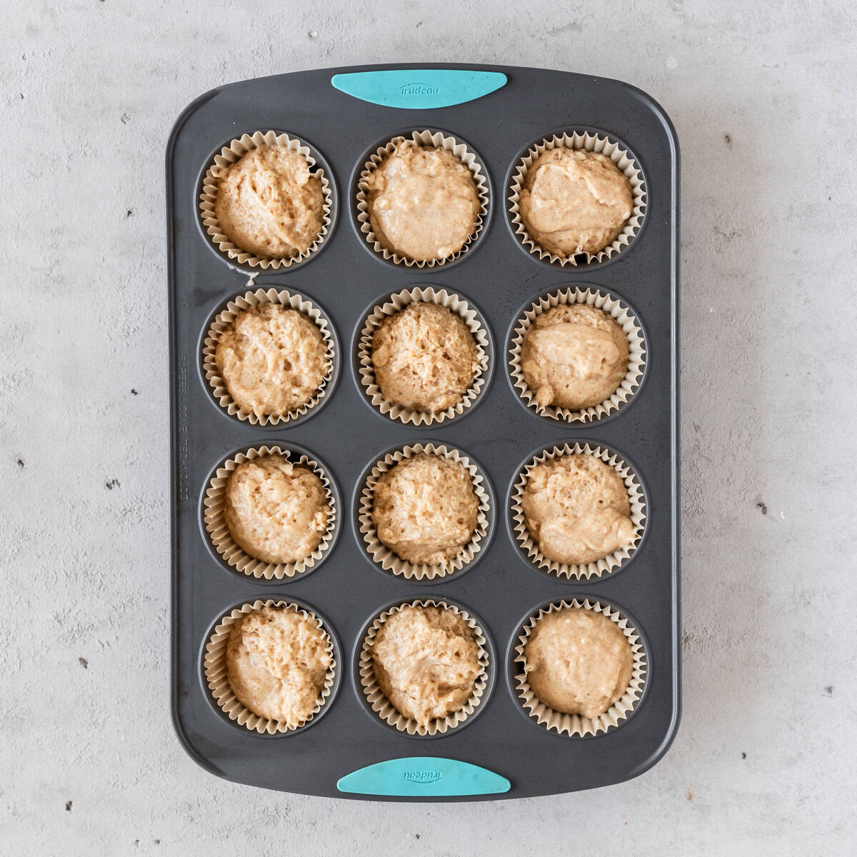 the muffin batter in a muffin tin before being baked.
