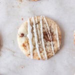 a cinnamon roll cookie on a tan background.
