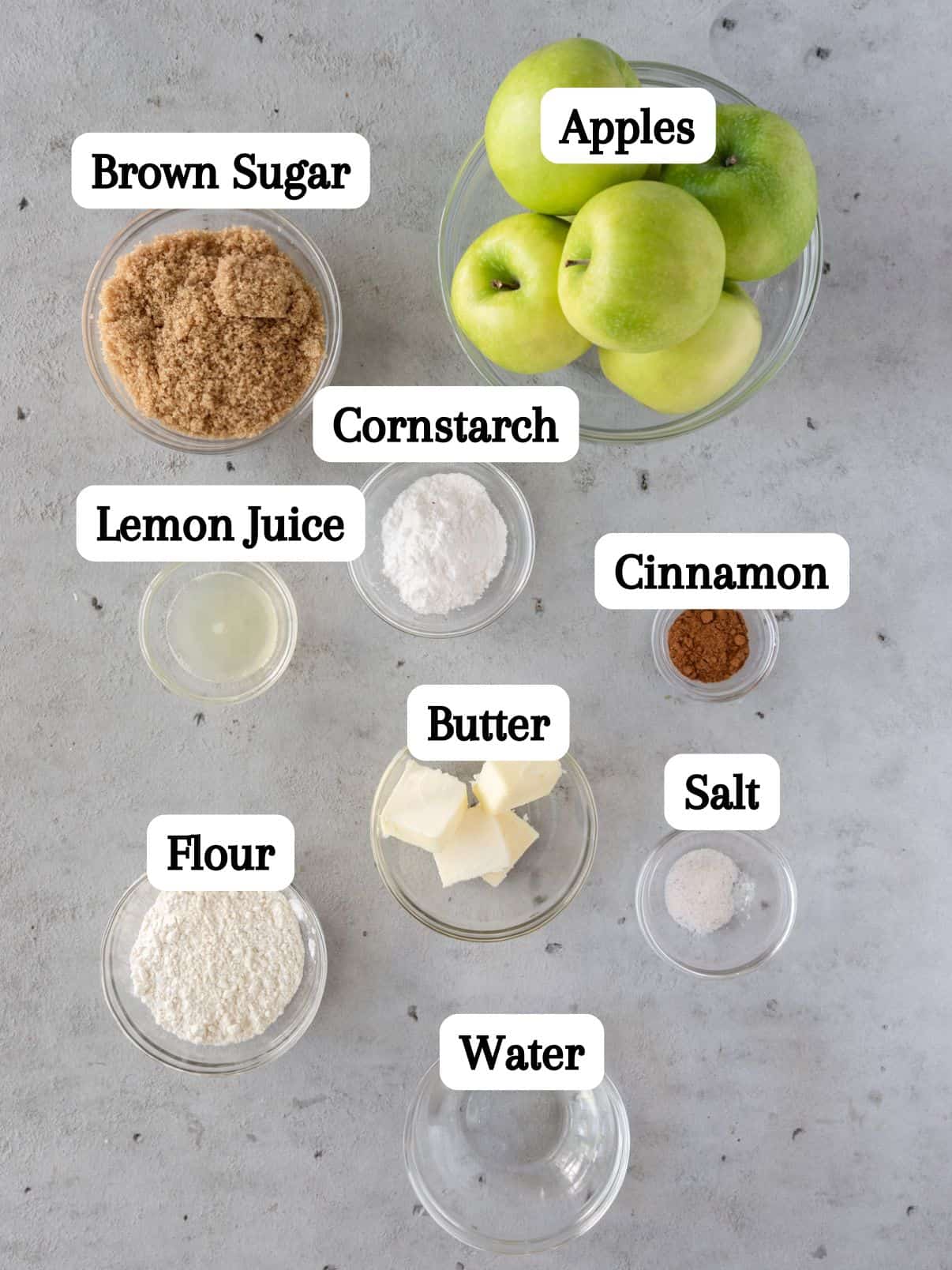 all of the ingredients laid out and labeled on a grey background.