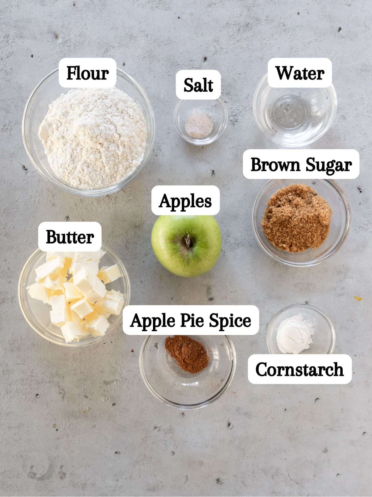 all of the ingredients laid out and labeled on a grey background.